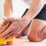 Physiotherapist guiding a patient through prehabilitation exercises using a resistance band